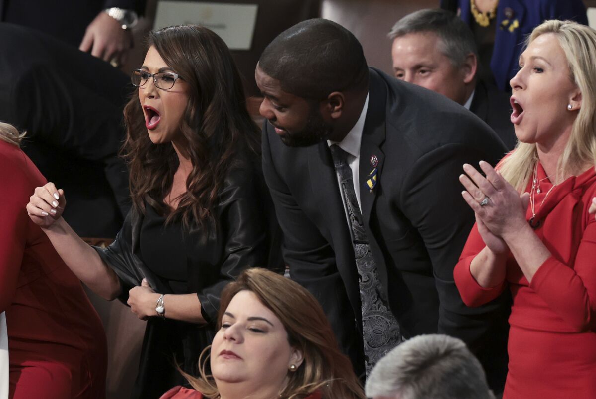 Lauren Boebert and Marjorie Taylor Greene shout from their seats