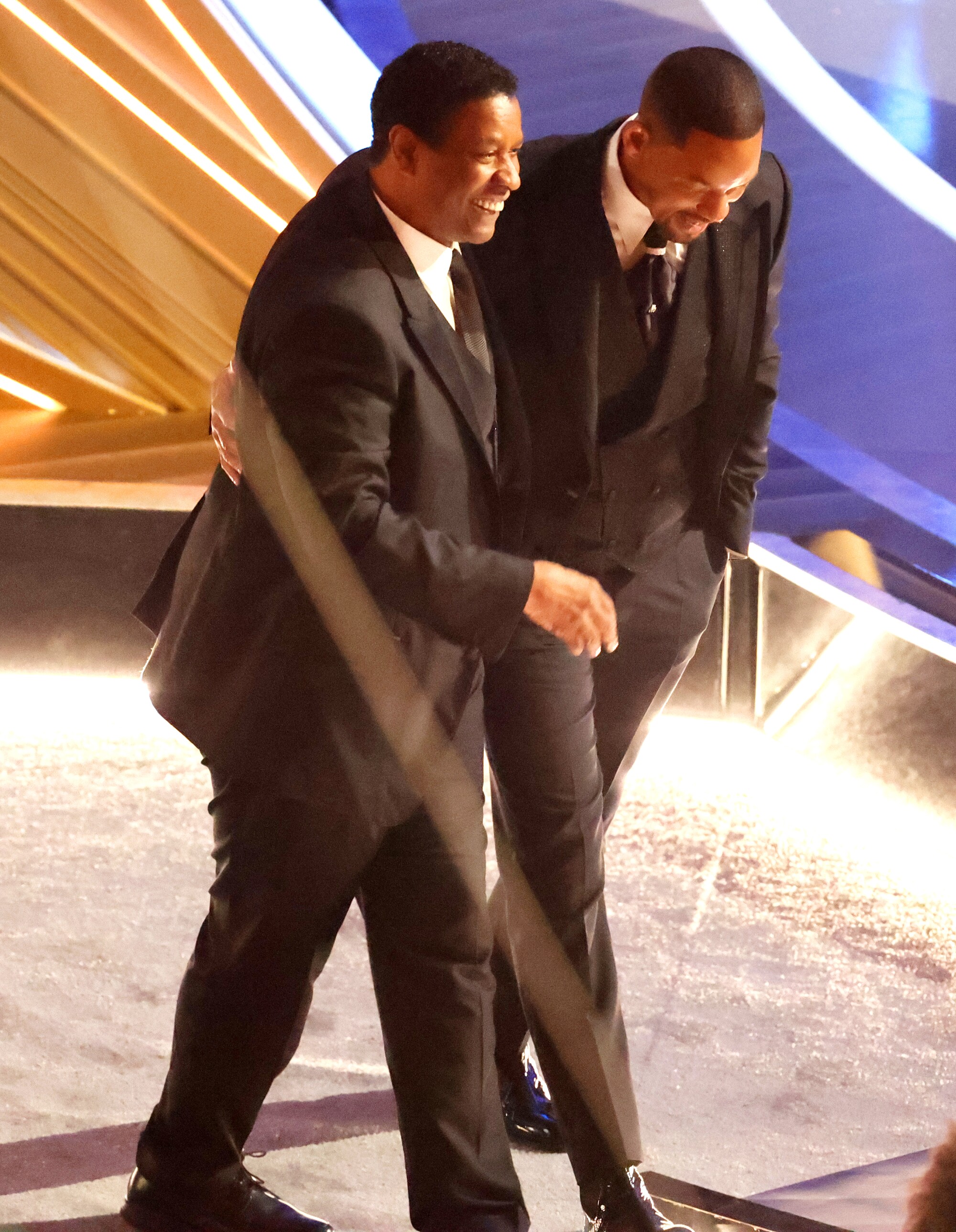 Denzel Washington comforts Will Smith during the 94th Academy Awards at the Dolby Theatre.
