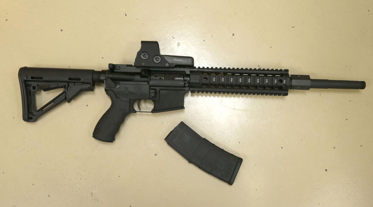 A semiautomatic rifle lying next to a detachable ammunition magazine