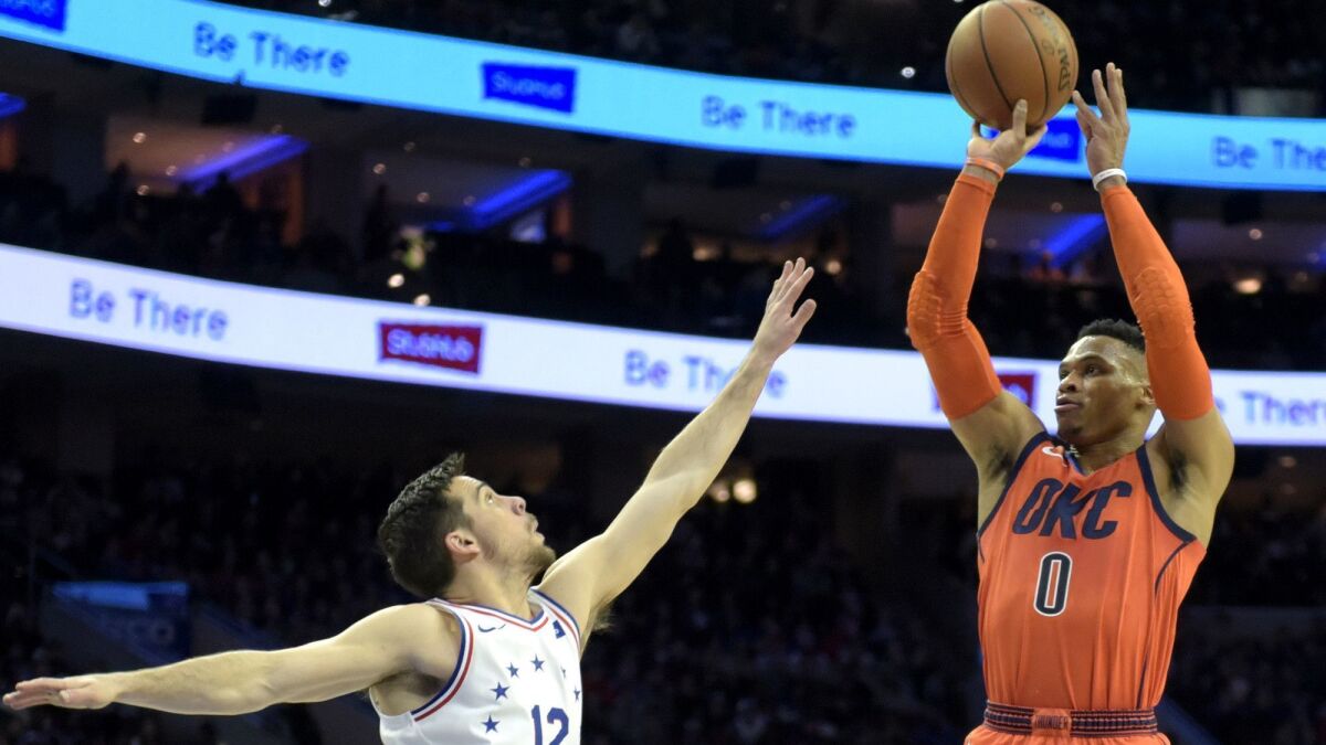 Thunder guard Russell Westbrook shoots over 76ers guard T.J. McConnell during the first half Saturday.