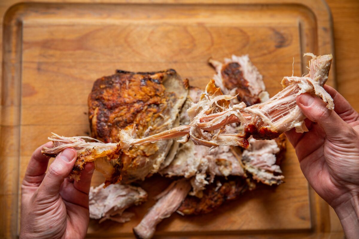 A slow-roasted "Boston butt," or simply "butt," cut of pork shoulder yields the best people-pleasing pulled pork.