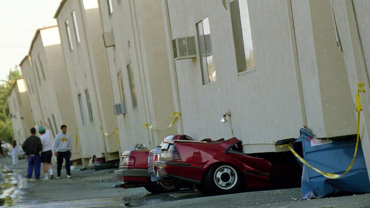 An apartment in Canoga Park on Victory Boulevard collapses on its flimsy ground story during the 1994 Northridge earthquake. (Boris Yaro / Los Angeles Times)