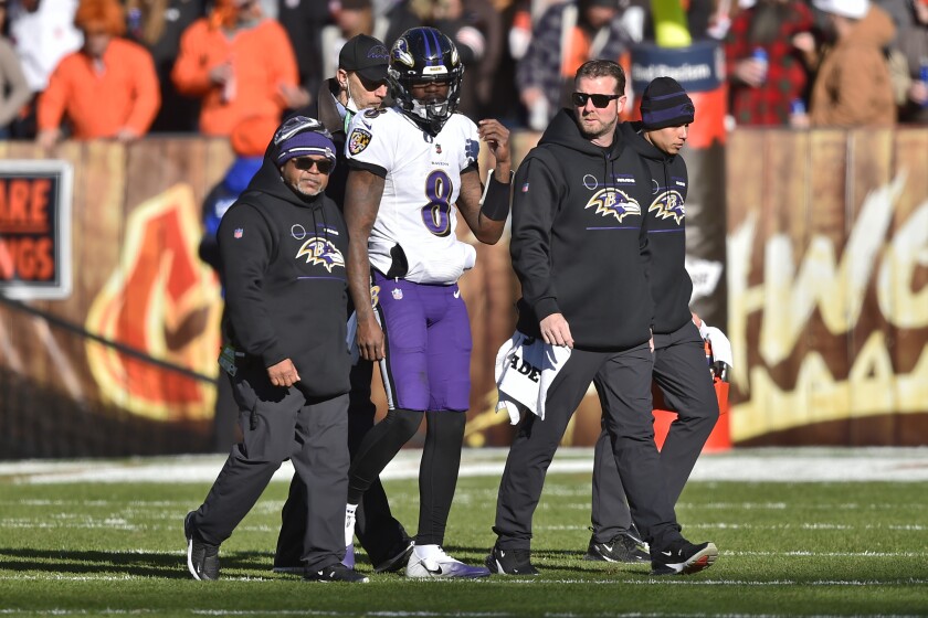 Baltimore Ravens quarterback Lamar Jackson (8) walks off the field with an injury during the first half of an NFL football game against the Cleveland Browns, Sunday, Dec. 12, 2021, in Cleveland. (AP Photo/David Richard)