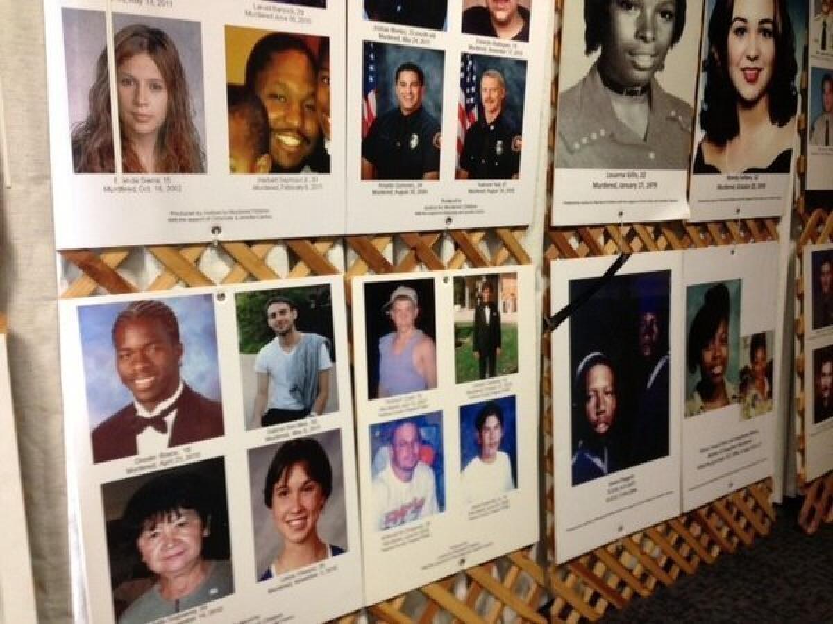 Photos of victims of unsolved homicides are displayed at a summit at the L.A. County Sheriff's Department headquarters in Monterey Park.