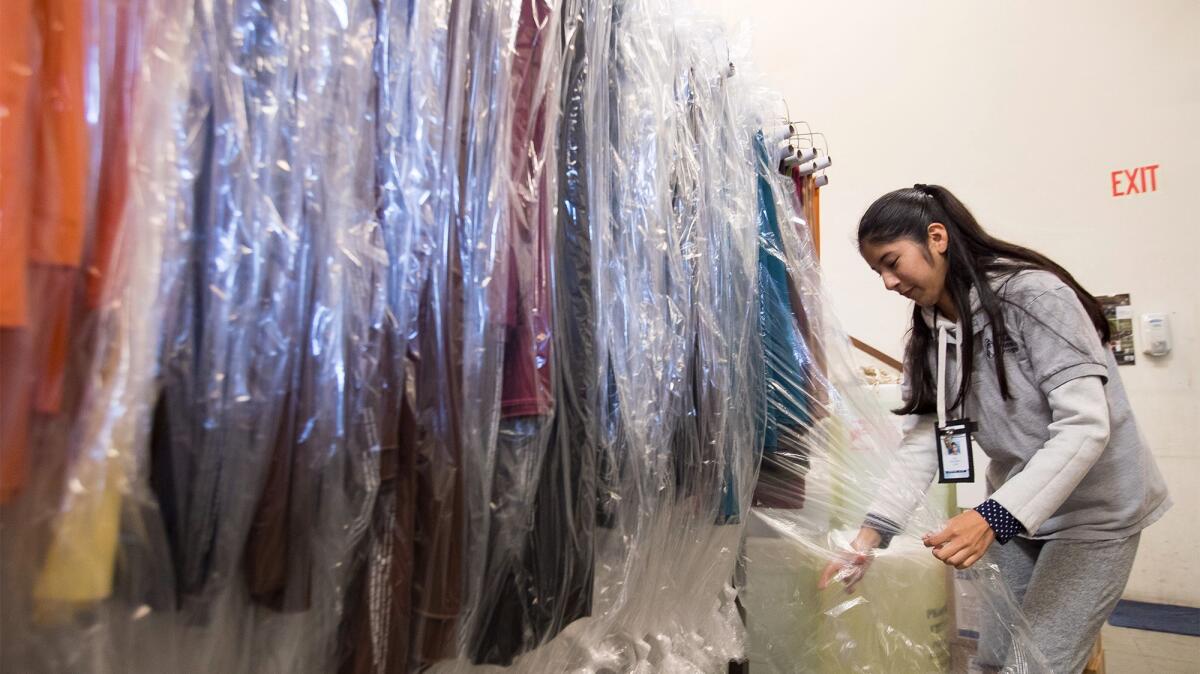 Luz Gonzalez, 21, sorts tablecloths at Baker Party Rentals in Costa Mesa, where she participates in STEP, the Newport-Mesa Unified School District's Seamless Transition Enrichment Program for special-needs students who have graduated high school.