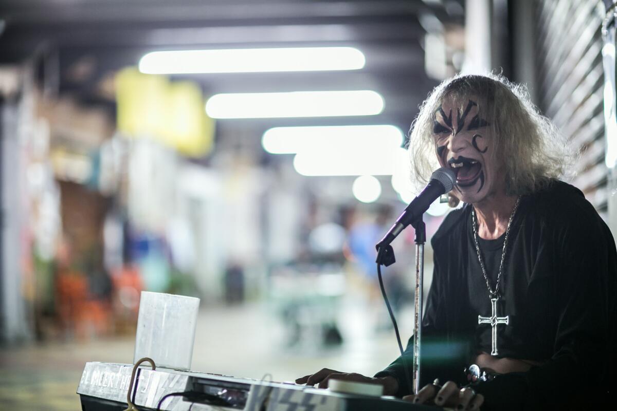 El Muertho performs in the Pasaje Rodriguez. The performer took to the streets to sing after health problems prevented him from working as a mechanic. His low-tech performances have garnered him a cult following.