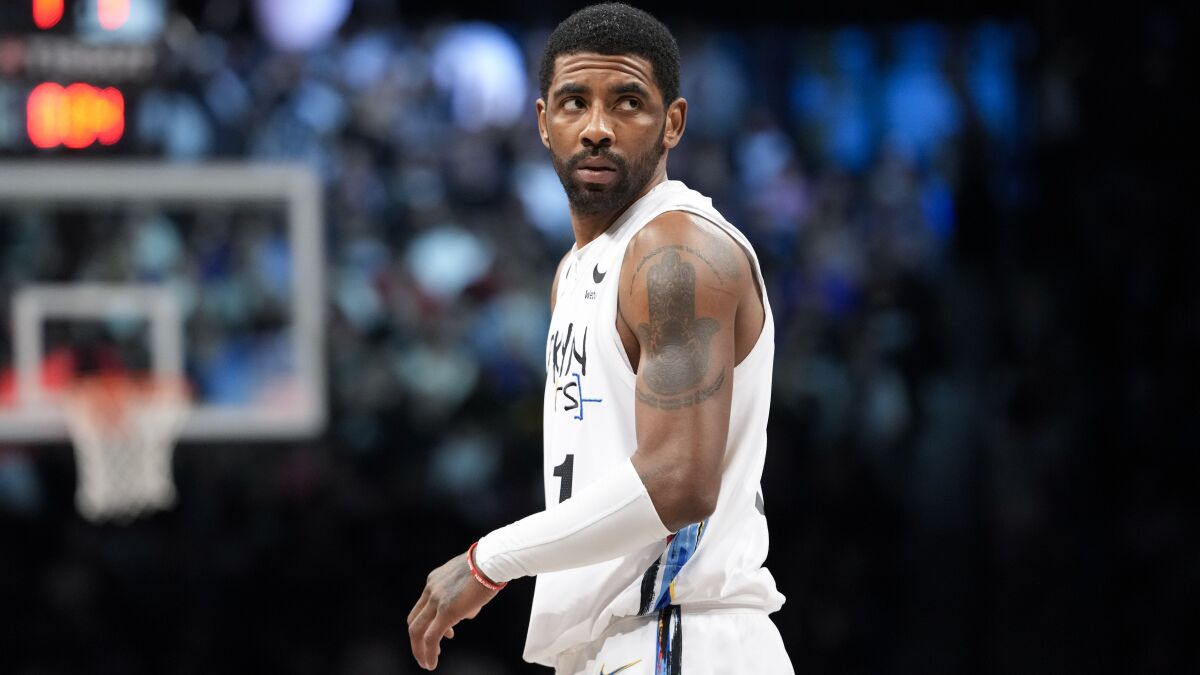 Nets guard Kyrie Irving looks toward the baseline during a break in play.
