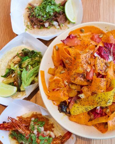 A bowl of carrot salad and tacos: shrimp, suadero and Brussels sprouts from Enrique Olvera's Atla