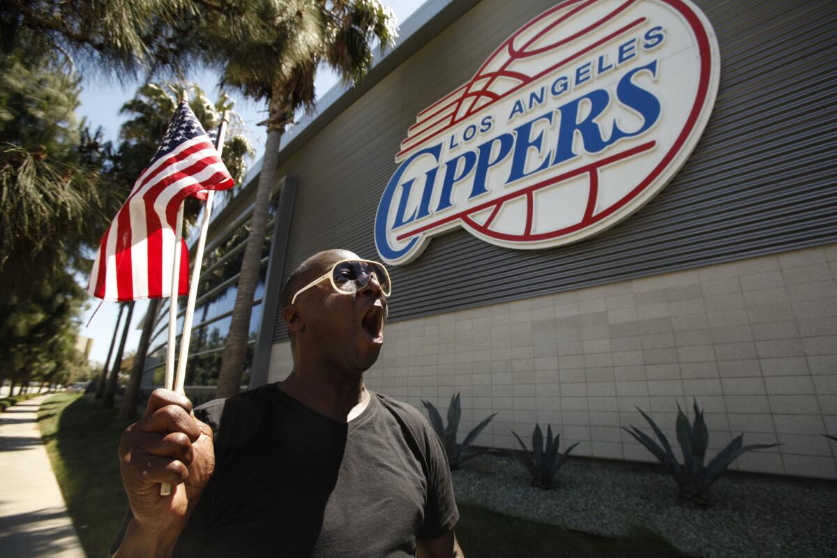 DeWayne Williams of Los Angeles marches in front of Clippers headquarters in Playa Vista on Monday, chanting "freedom and justice for all -- no racism -- we don't need it."