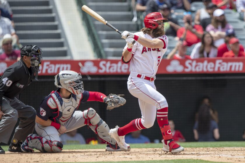 Los Angeles Angels' Brandon Marsh, right, hits an RBI single with Cleveland Guardians catcher Austin Hedges.