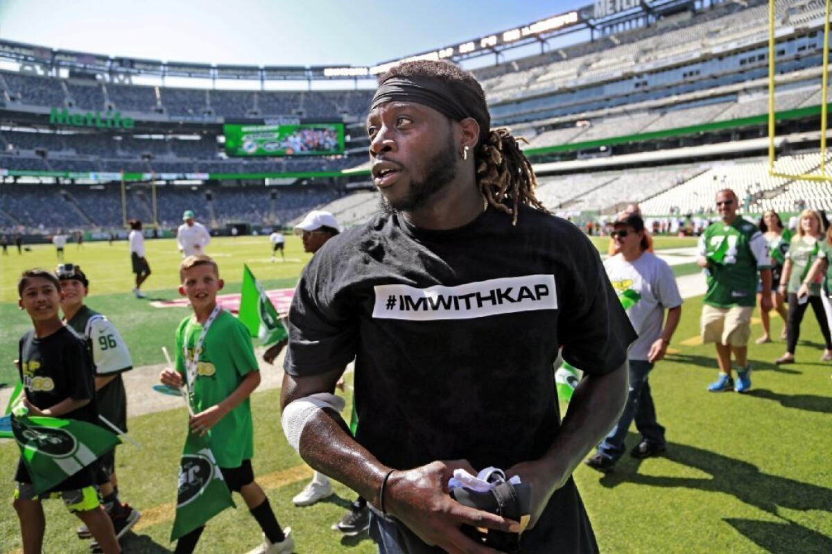 Miami Dolphins running back Jay Ajayi wears a T-shirt in support of Colin Kaepernick before a Sept. 24 game against the New York Jets in East Rutherford, N.J. (Al Diaz / Miami Herald / Associated Press)