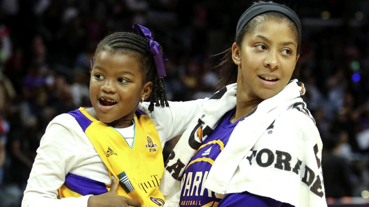 Sparks star Candace Parker holds daughter Lailaa after a WNBA playoff game against the Sky on Sept. 30, 2016.