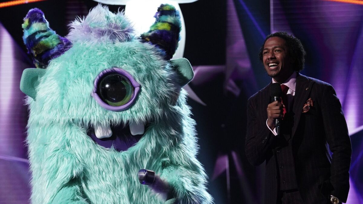 Monster and host Nick Cannon in the "Mask On Face Off" series premiere
