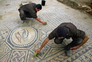 File - Prisoners work at a nearly 1,800-year-old decorated floor from an early Christian prayer hall discovered by Israeli archaeologists on Sunday, November 6, 2005 in the Megiddo prison. Israeli officials are considering uprooting the mosaic and loaning it to the controversial Museum of the Bible in Washington D.C., a proposal that has upset archaeologists and underscores the hardline government's close ties with evangelical Christians in the U.S. (AP Photo/Ariel Schalit, File)