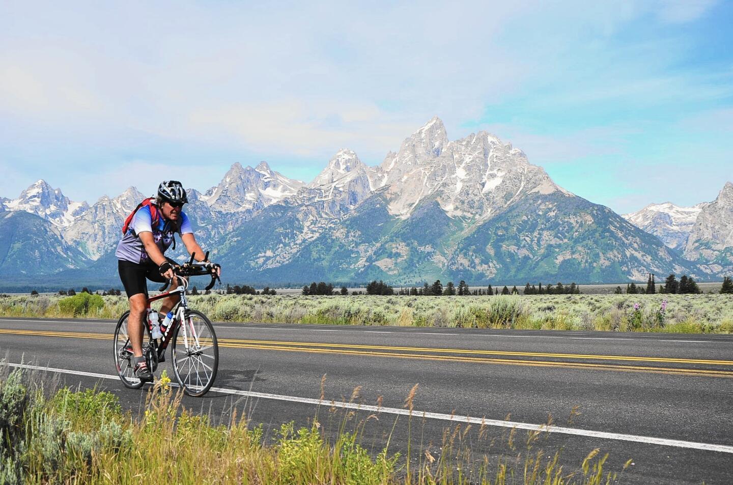 Paul Meincke rides past the beautiful Tetons on the way to the Continental Divide.