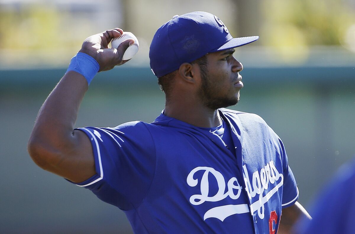 Dodgers outfielder Yasiel Puig warms up during a spring training workout on Feb. 26.
