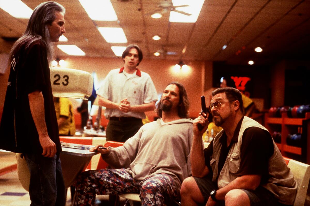 Jimmy Dale Gilmore, Steve Buscemi, Jeff Bridges and John Goodmantalk in a bowling alley in "The Big Lebowski."