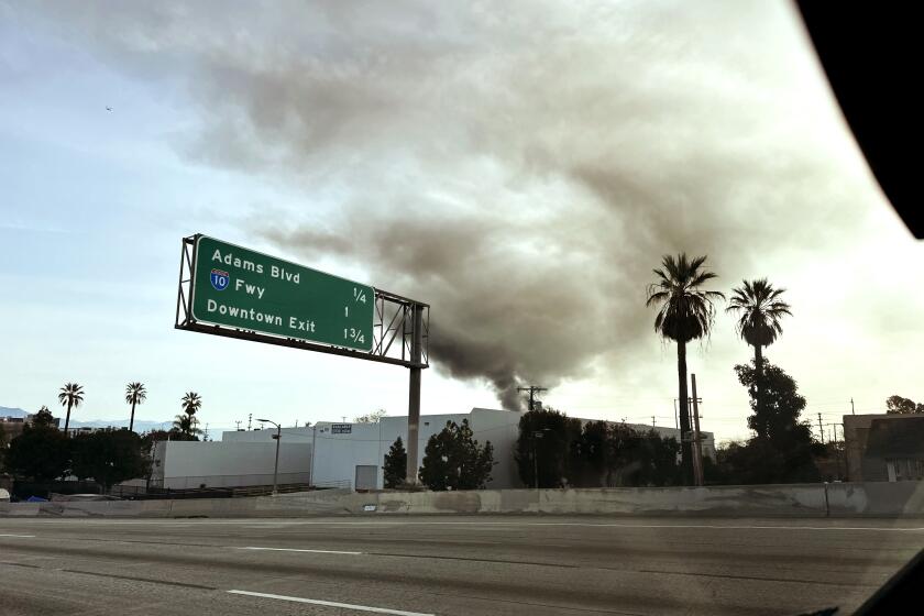 Los Angeles, California-March 9, 2024-Five firefighters were hospitalized Saturday morning after noticing an unusual burning sensation on their faces while responding to a blaze at an unpermitted cannabis operation in downtown Los Angeles on March 9, 2024. Brian Humphrey, a Los Angeles Fire Department spokesperson, said there was concern that the sensation may have resulted from burning chemicals inside the engulfed two-story, brick building south of the Arts District. (Andrew Gombert/Los Angeles Times)