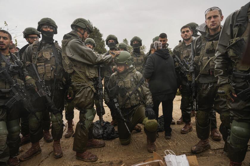 Israeli soldiers prepare to enter the Gaza Strip, at a staging area near the Israeli-Gaza border, in southern Israel, Wednesday, Dec. 13, 2023. The army is battling Palestinian militants across Gaza in the war ignited by Hamas' Oct. 7 attack into Israel. (AP Photo/Ohad Zwigenberg)