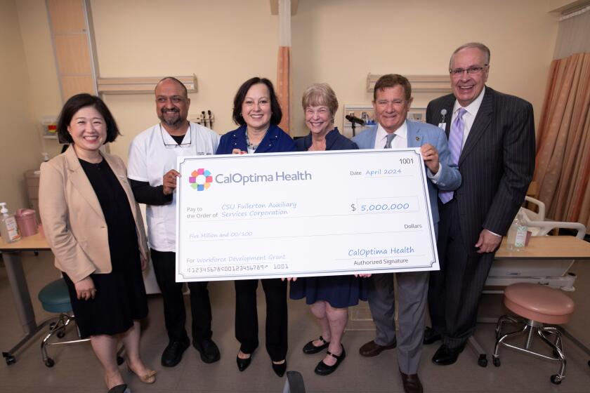 CalOptima Health leaders presented Cal State Fullerton with a ceremonial $5 million check to boost nurse staffing in O.C.
