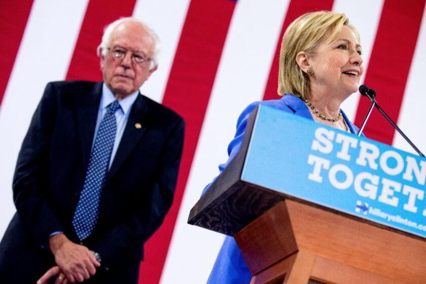 Democratic presidential candidate Hillary Clinton accompanied by Democratic presidential candidate Sen. Bernie Sanders, I-Vt., at a rally at Portsmouth High School in Portsmouth, N.H. on July 12.