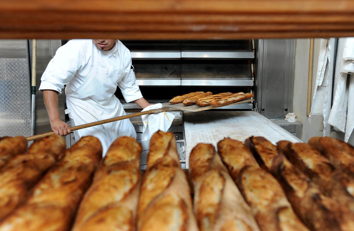 Fresh-baked baguettes are removed from the oven at Gjusta.