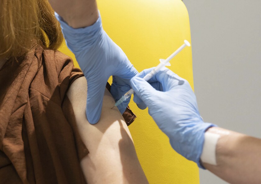 A volunteer in Oxford, England, is administered the COVID-19 vaccine developed by AstraZeneca and Oxford University.