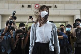 FILE - Hong Kong activist Agnes Chow arrives at a court in Hong Kong, Monday, Nov. 23, 2020. One of Hong Kong’s best-known pro-democracy activists, who moved to Canada to pursue further studies, said she would not return to the city to meet her bail conditions, becoming the latest politician to flee Hong Kong under Beijing's crackdown on dissidents. (AP Photo/Vincent Yu, File)