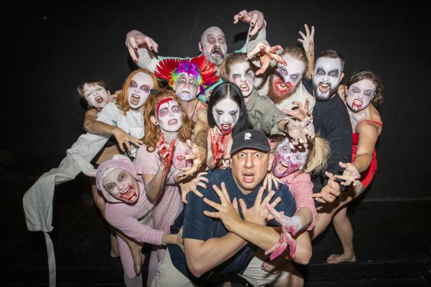 NORTH HOLLYWOOD, CALIF. -- SATURDAY, OCTOBER 26, 2019: Founder Zombie Joe, lower center, and the cast of the show, “Urban Death Tour of Terror” poses before a show at Zombie Joe's Underground Theatre in North Hollywood. Each year the theatre does a show called "Urban Death Tour of Terror“ where people go through a haunted maze and watch a R-rated, graphic horror show. Photo taken on Oct. 26, 2019. (Allen J. Schaben / Los Angeles Times)