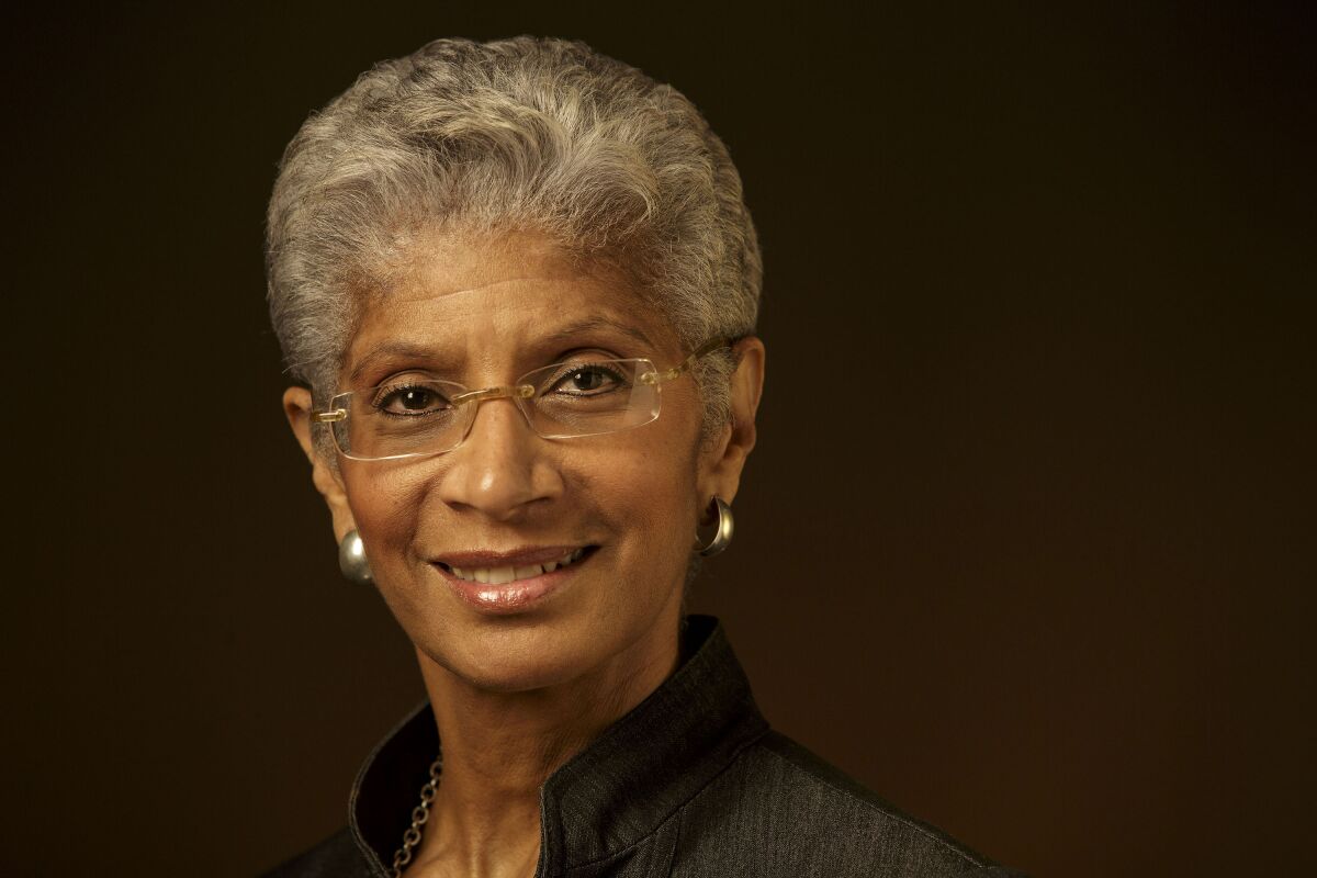 A smiling woman with short gray hair