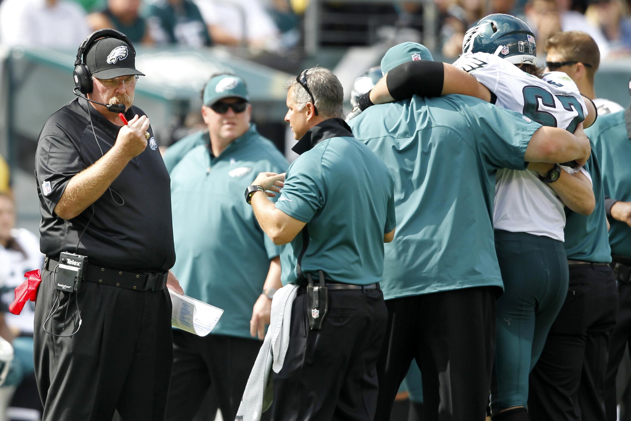  Eagles coach Andy Reid watches as Jason Kelce (62) is helped off the field in 2012.

