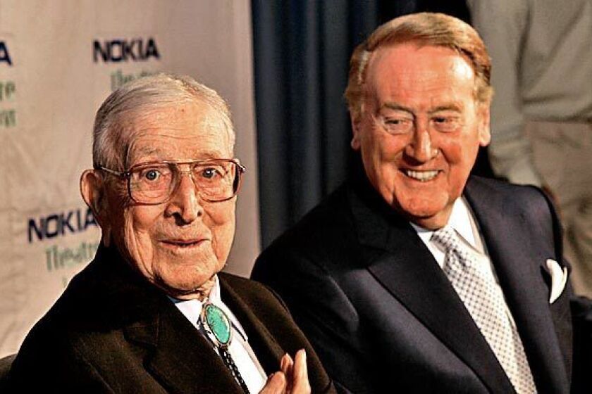 Sports legends John Wooden and Vin Scully takes photos backstage before they sit together on the Nokia Theater stage