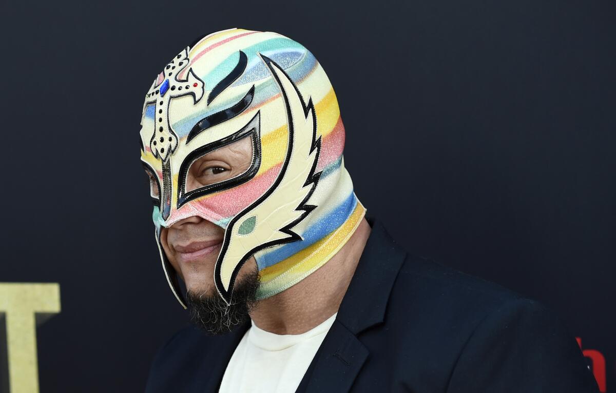 Professional wrestler Rey Mysterio poses at the premiere of the HBO documentary film "Andre the Giant."