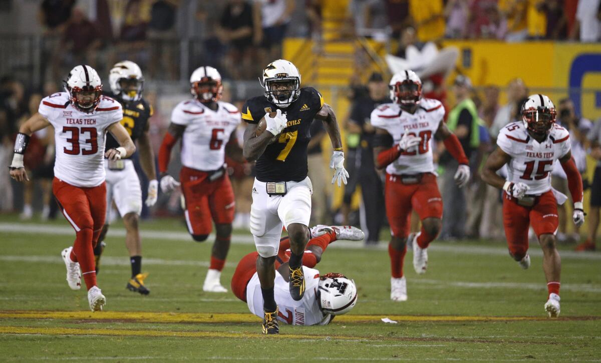 Arizona State running back Kalen Ballage (7) runs past Texas Tech defenders for his eighth touchdown on Sept. 10.