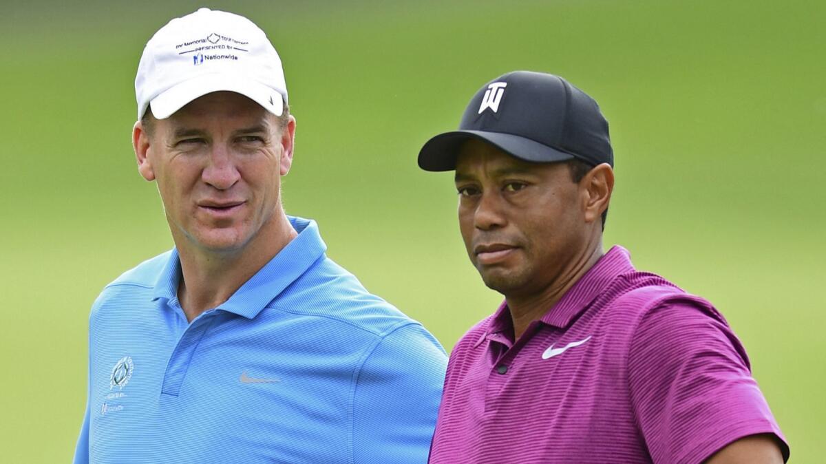 Peyton Manning, left, looks at Tiger Woods during the pro-am for the the Memorial golf tournament on May 30, 2018 in Dublin, Ohio.