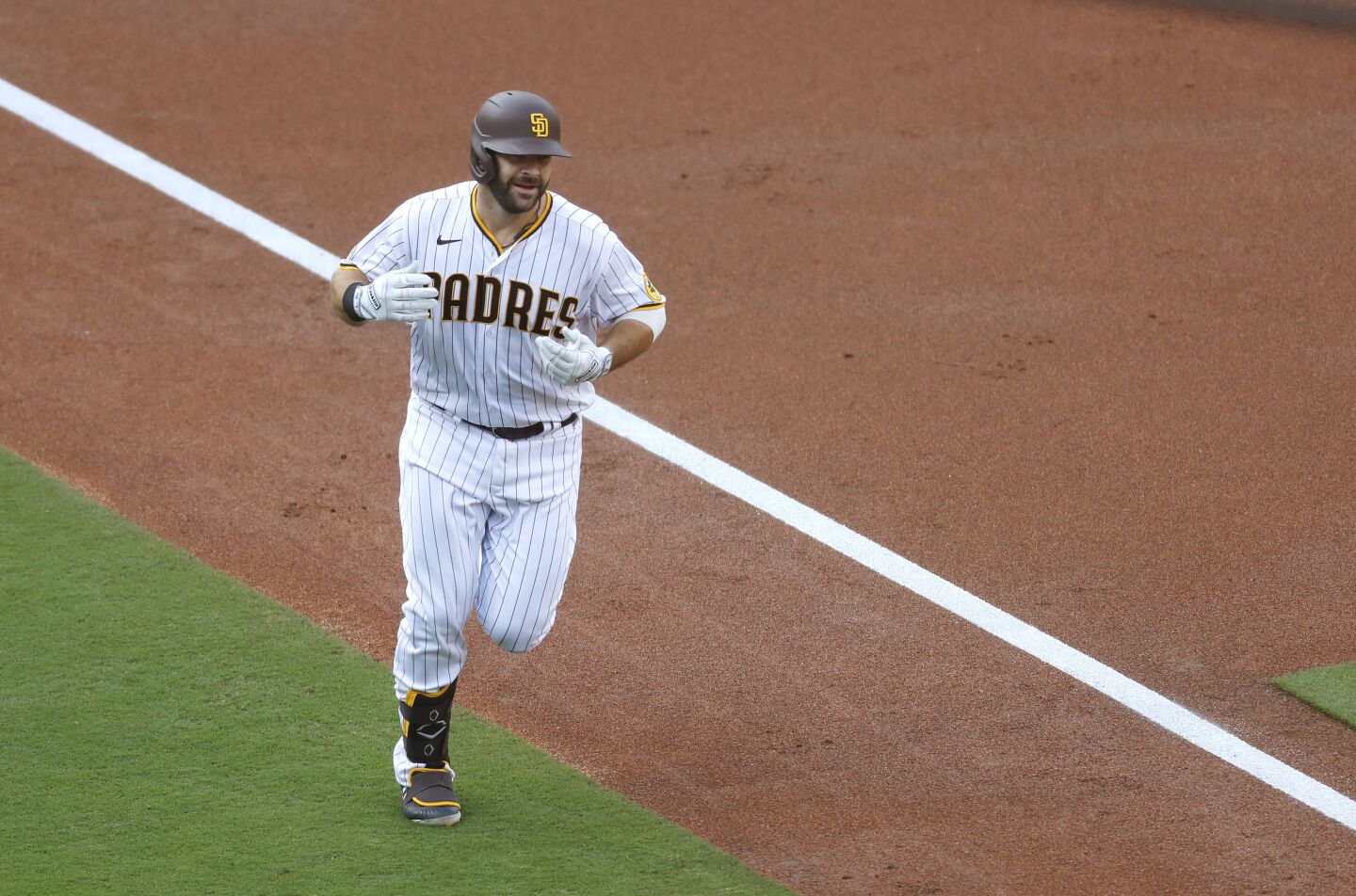 San Diego Padres Mitch Moreland rounds third base after hitting a two-run home run in the 1st inning against the Colorado Rockies on Wednesday, Sept. 9, 2020.