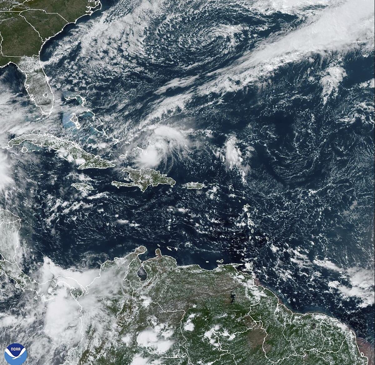 This satellite image provided by NOAA shows Hurricane Oscar over land masses.