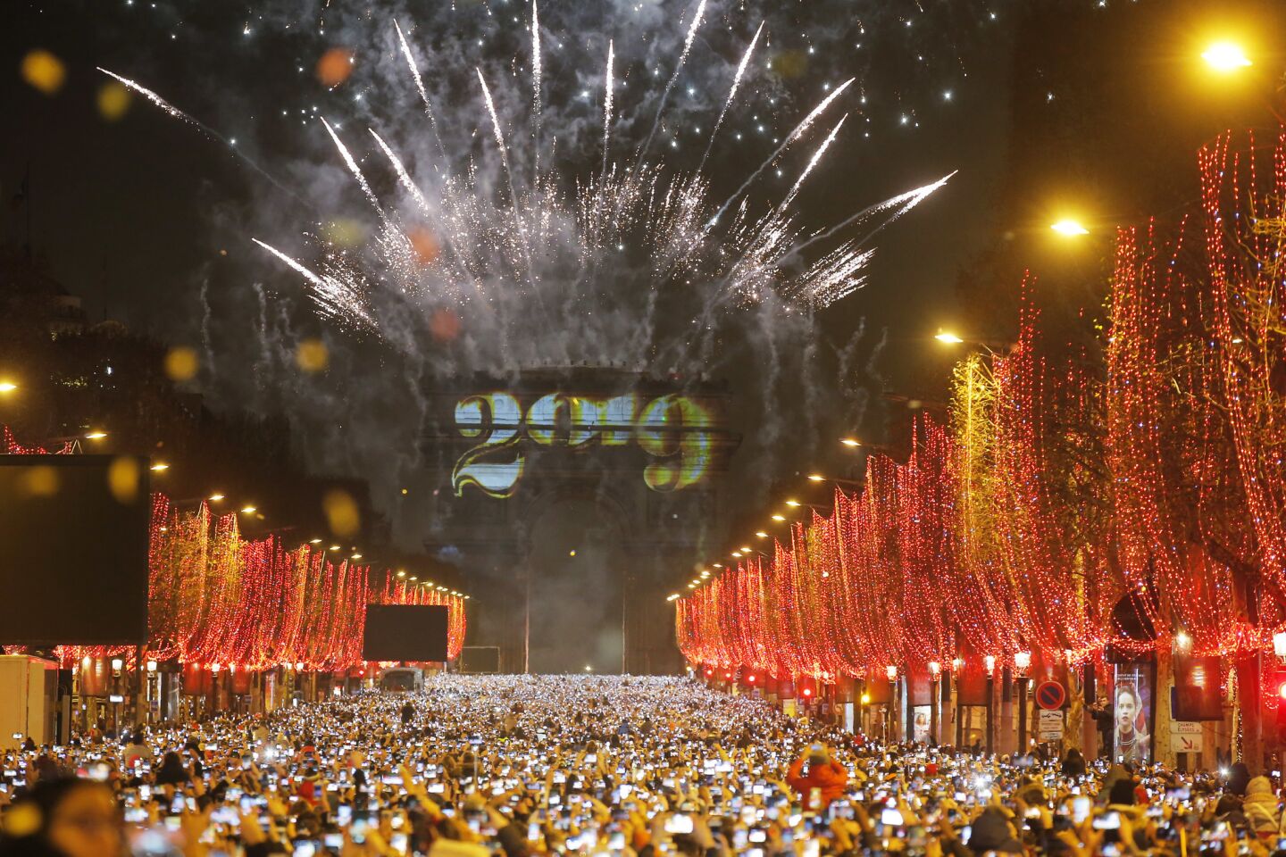 Fireworks illuminate the sky over the Arc de Triomphe in the first minutes of the new year.