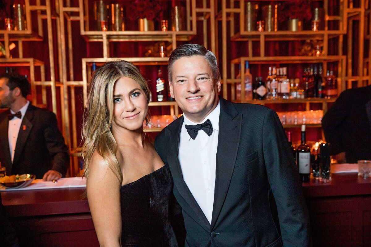 Jennifer Aniston and Netflix Chief Content Officer Ted Sarandos at the Netflix Golden Globes after party at the Waldorf Astoria.