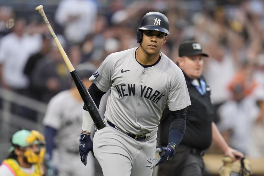 New York Yankees' Juan Soto tosses his bat after hitting a two-run home run during the third inning of a baseball game against the San Diego Padres, Friday, May 24, 2024, in San Diego. (AP Photo/Gregory Bull)