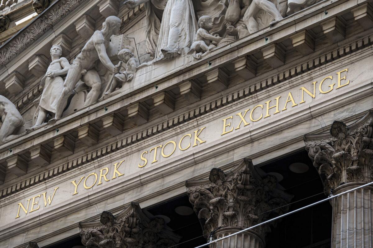 The New York Stock Exchange signage glistens in the noon sun 