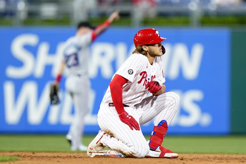 Philadelphia Phillies' Alec Bohm, right, reacts after getting tagged out while trying to stretch a single during the sixth inning of baseball game against the Miami Marlins, Tuesday, May 18, 2021, in Philadelphia. (AP Photo/Matt Slocum)