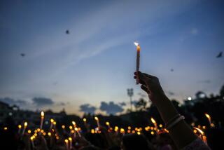 CORRECTS TO CHANGE THE TERM MURDER TO KILLING - Women hold candles as they stage a protest against the rape and killing of a trainee doctor at a government hospital last week, in Guwahati, India, Friday, Aug. 16, 2024. (AP Photo/Anupam Nath)