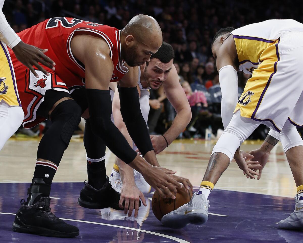 Bulls forward Taj Gibson, left, competes with Lakers forward Larry Nance Jr. and guard D'Angelo Russell, right, for the ball during the first half on Nov. 20.