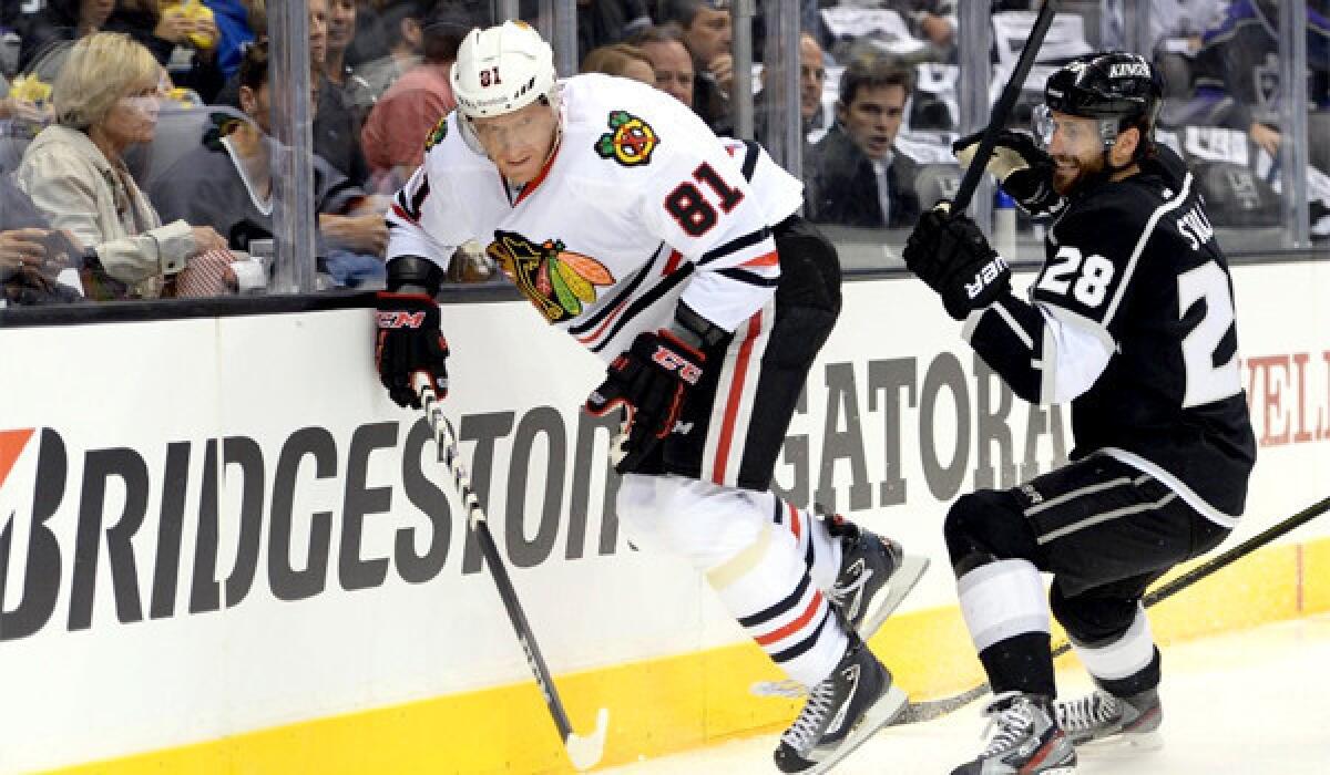 The Kings are a "great defensive team," says Marian Hossa, left, of the Blackhawks, who play L.A. on Thursday night at Staples Center. Jarret Stoll of the Kings is at right.