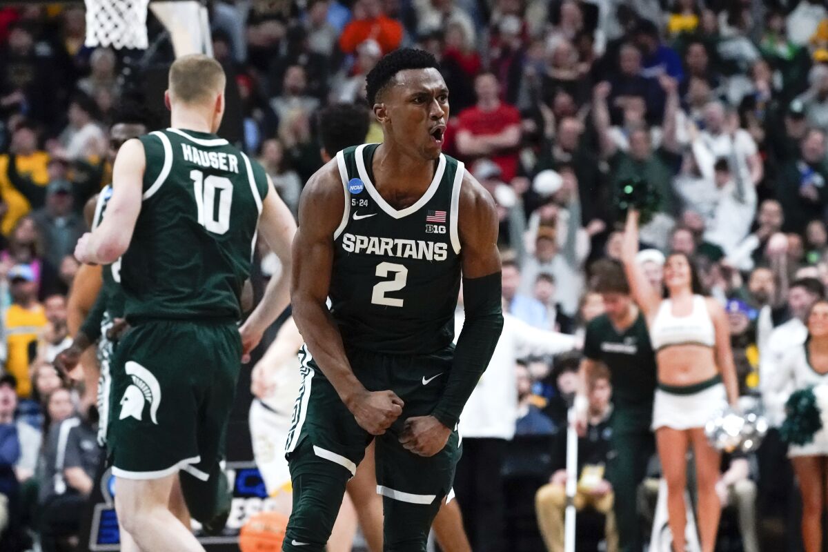 Michigan State guard Tyson Walker (2) reacts after a basket against Marquette in the second half of a second-round men's college basketball game in the NCAA Tournament Sunday, March 19, 2023, in Columbus, Ohio. (AP Photo/Paul Sancya)