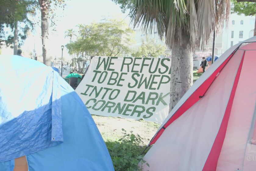 Advocates rally in Echo Park in an effort to prevent a shutdown of a homeless encampment