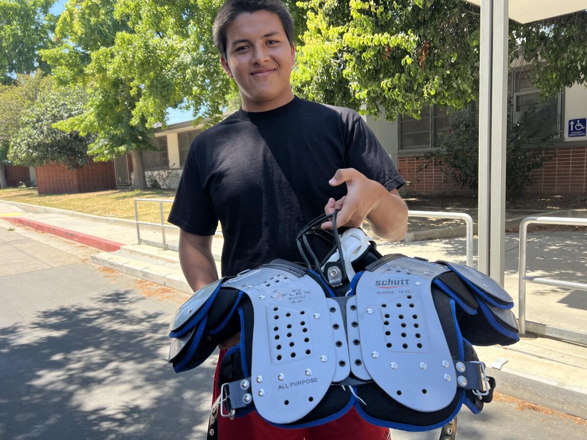Tristan Cordero of Cleveland showing off his new shoulder pads before practice on Thursday.