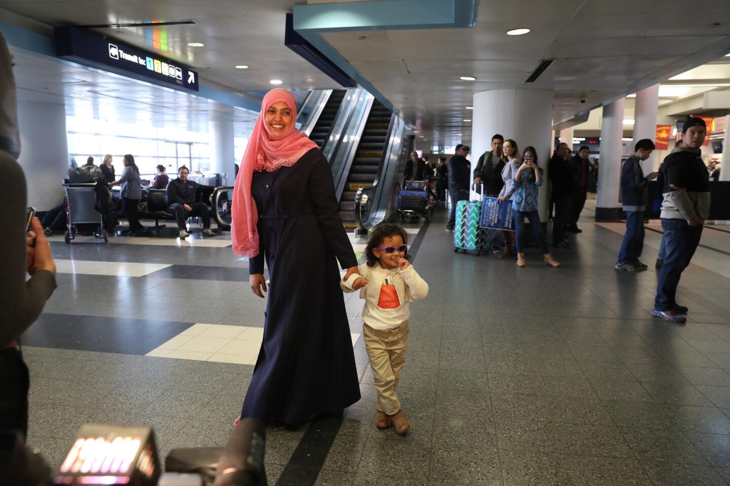 Haifa Abdulwahab Hussein Mohammed, of Yemen, and her daughter, Rudaynah Jemal, 3, walk through O'Hare International Airport on Feb. 5, 2017. The two had been set to arrive the previous Saturday but were delayed because of President Donald Trump's travel ban.