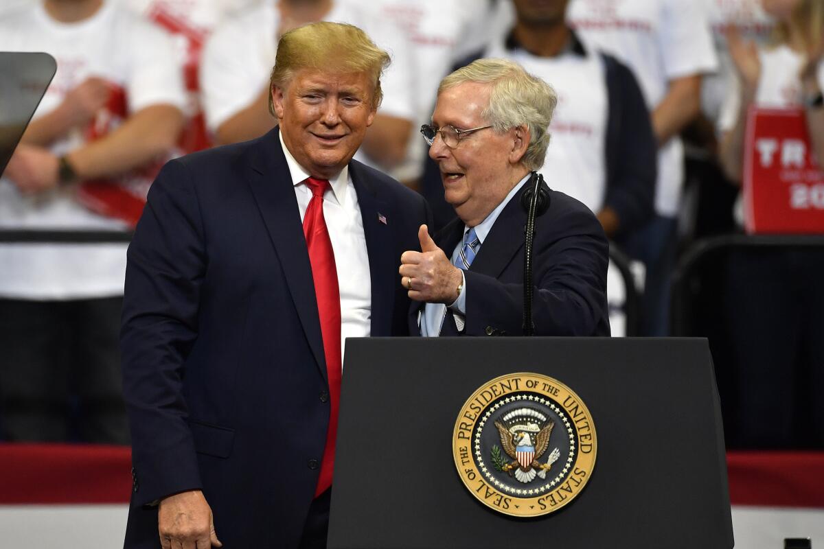Then-President Trump and Senate  GOP leader Mitch McConnell onstage at a rally